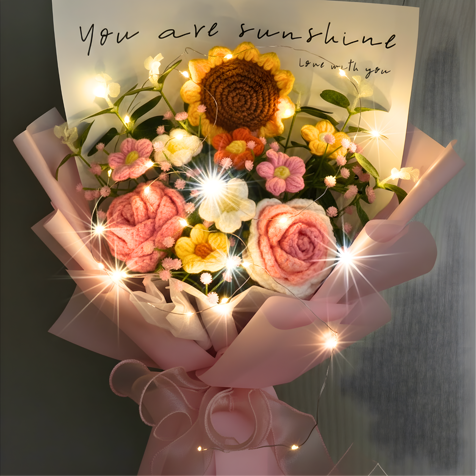 Bouquet of flowers with lights and a card reading 'You are sunshine, love you' on a dark background.